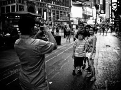 Photo of tourists taking each other's photo in Times Square, New York