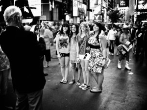 Photo of tourists taking each other's photo in Times Square, New York