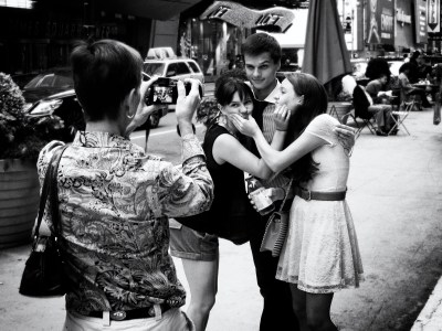 Photo of tourists taking each other's photo in Times Square, New York
