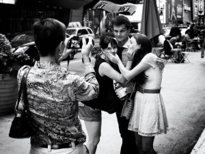 Photo of tourists taking each other's photo in Times Square, New York