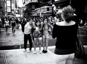 Photo of tourists taking each other's photo in Times Square, New York