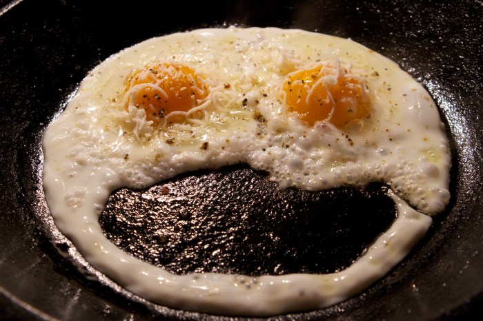 Smiley face made of frying eggs