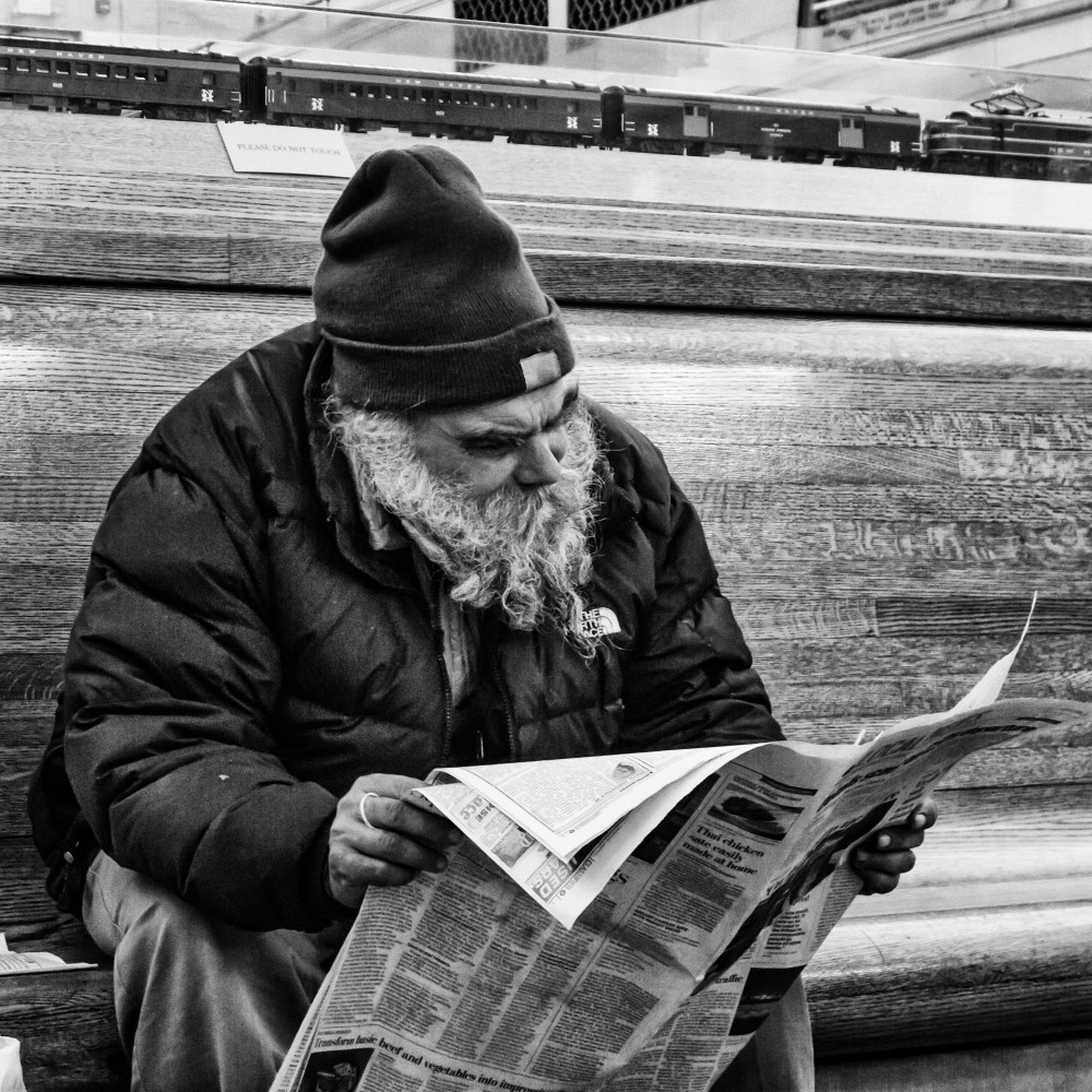 old man reading a paper
