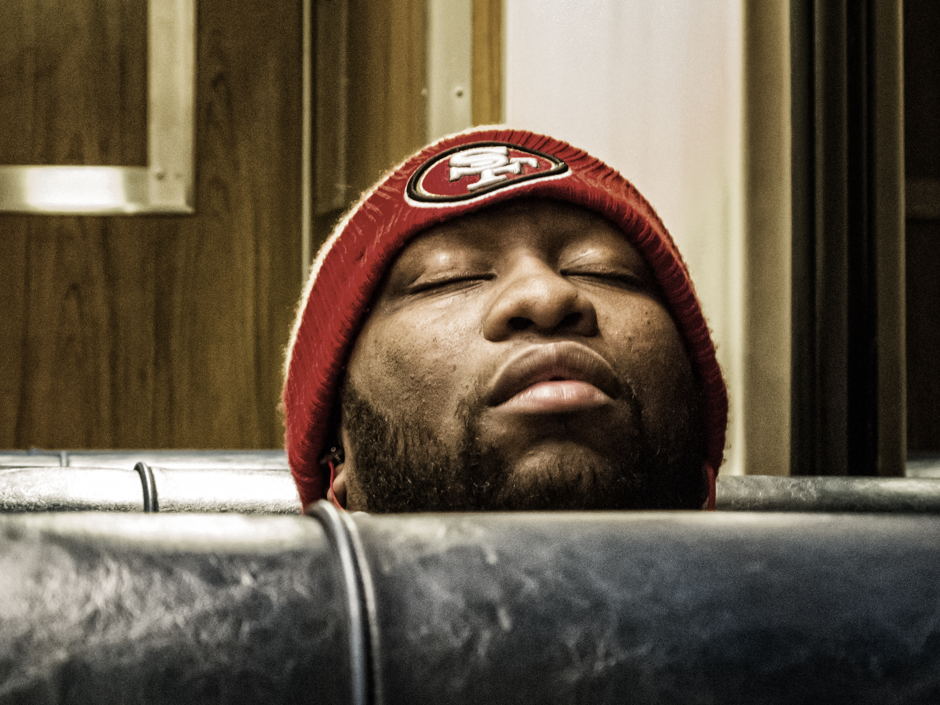 man sleeping on train