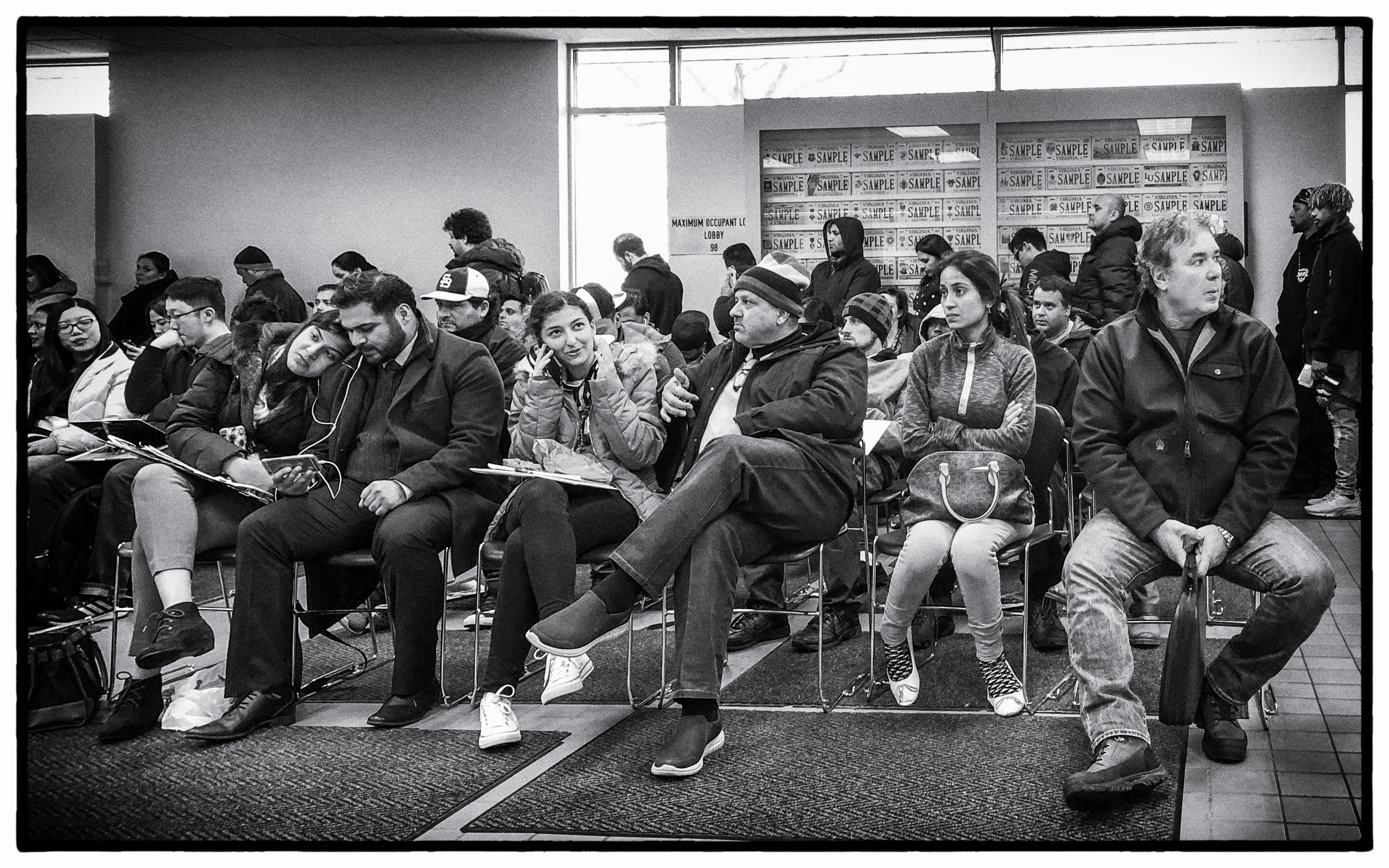 bored people waiting at the DMV office