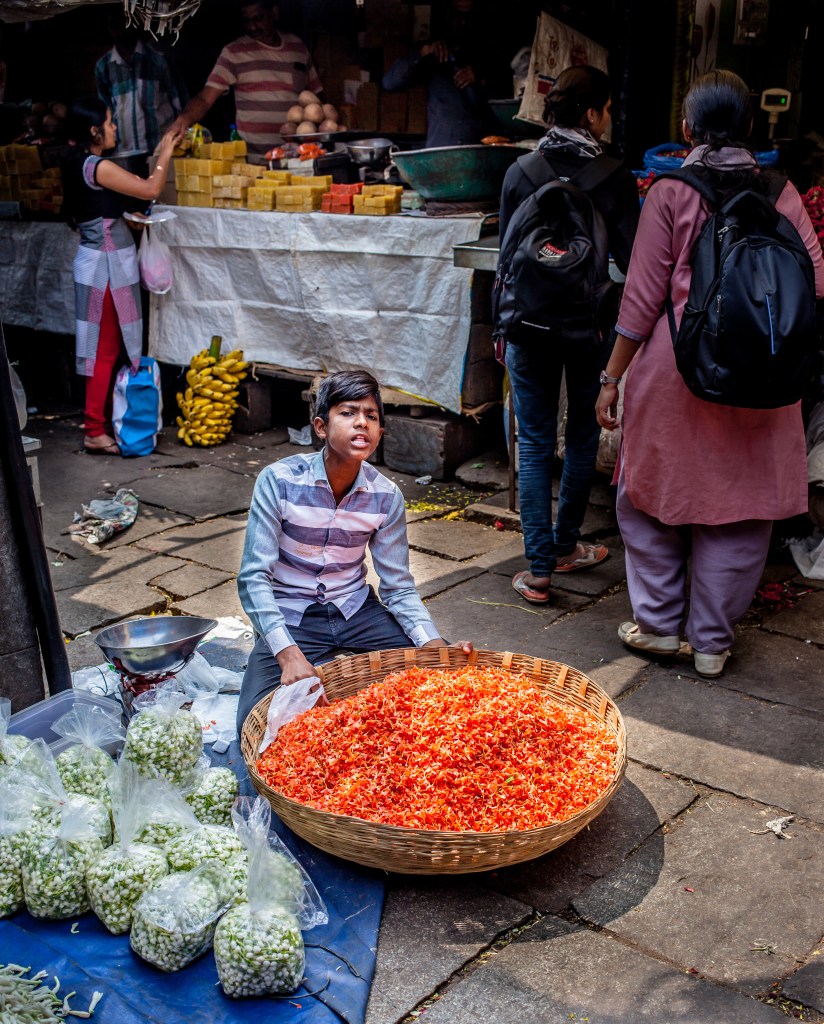 boy selling flowers in India